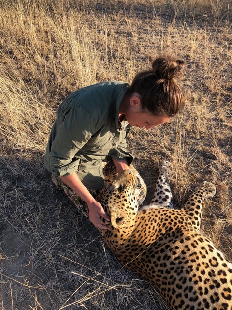 Britt Longoria kneeling before Leopard Trophy